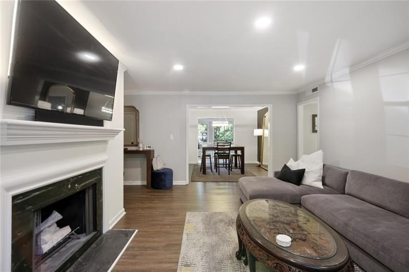 162 Elysian Way Northwest Atlanta, GA 30327 - Photo 11 of 32 a living room with furniture a fireplace and a flat screen tv