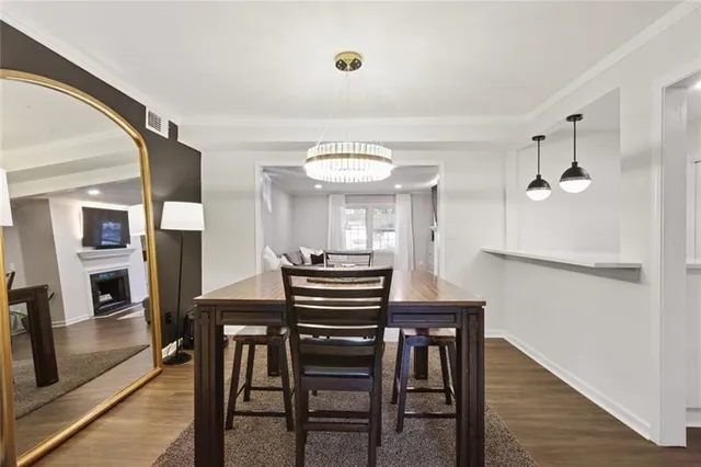 a view of a dining room with furniture and a chandelier