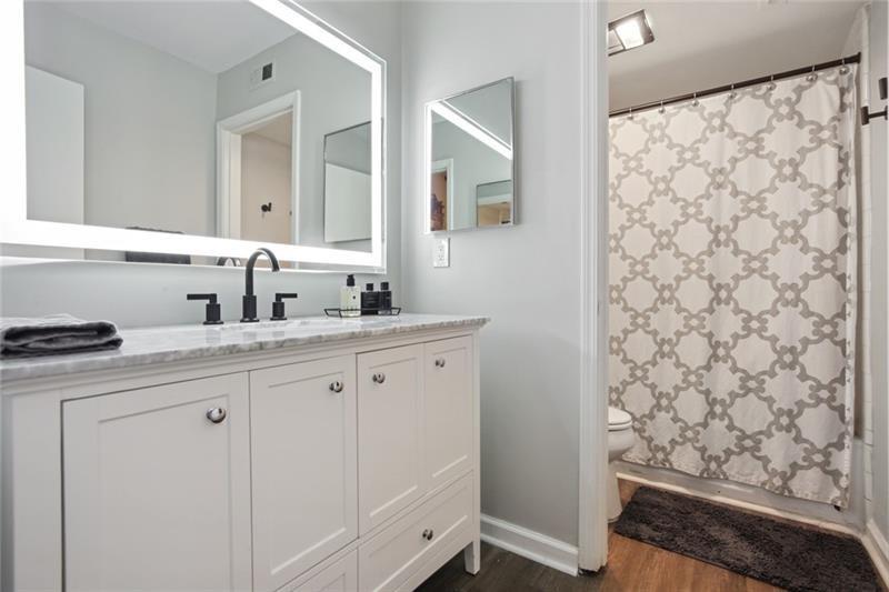 162 Elysian Way Northwest Atlanta, GA 30327 - Photo 18 of 32 a bathroom with a sink a vanity and a mirror