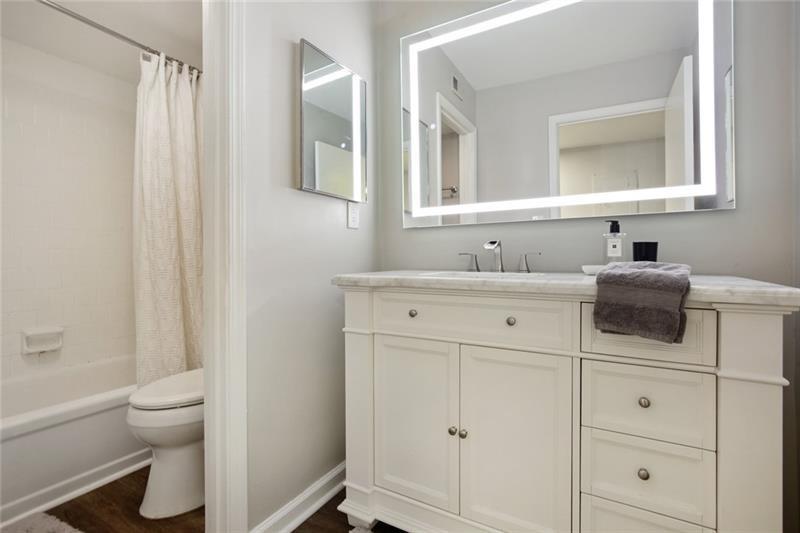 162 Elysian Way Northwest Atlanta, GA 30327 - Photo 21 of 32 a bathroom with a sink toilet vanity and tub