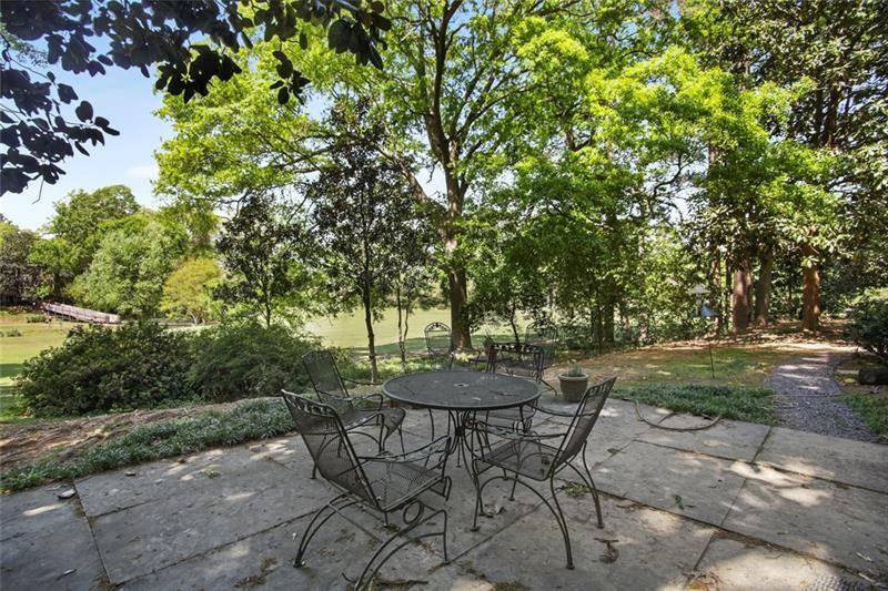 162 Elysian Way Northwest Atlanta, GA 30327 - Photo 25 of 32 a view of a backyard with table and chairs plants and trees