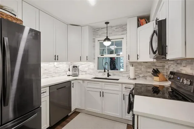 a kitchen with a sink stove and refrigerator