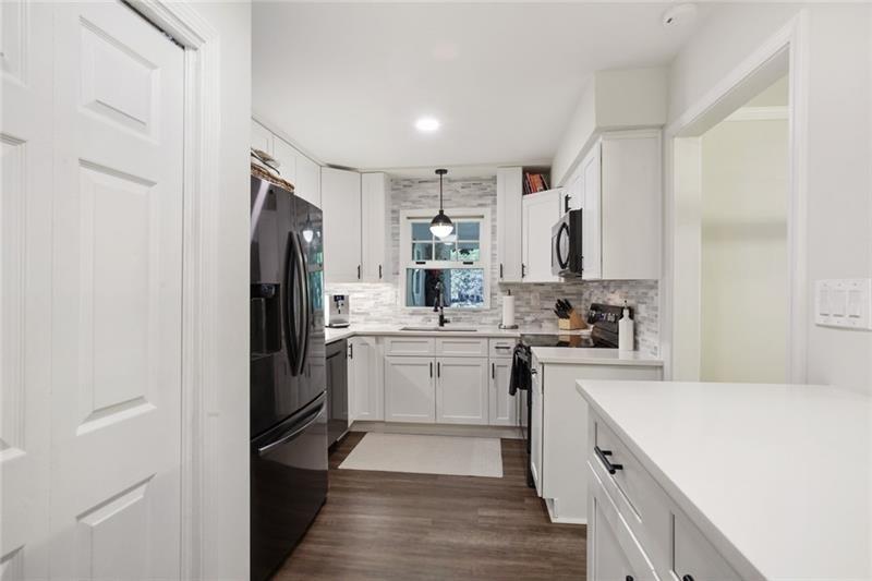 162 Elysian Way Northwest Atlanta, GA 30327 - Photo 4 of 32 a kitchen with a refrigerator a sink and cabinets