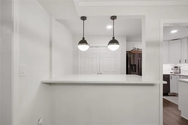 a kitchen with kitchen island a center island and wooden floor