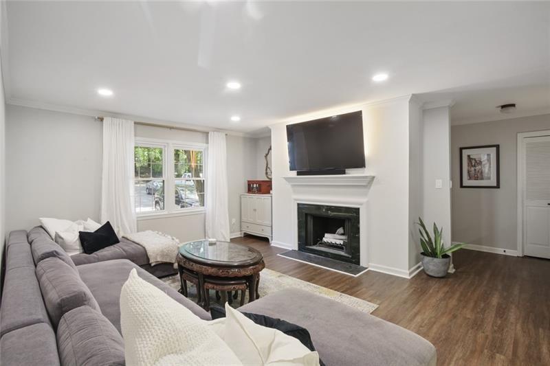 162 Elysian Way Northwest Atlanta, GA 30327 - Photo 10 of 32 a living room with furniture a fireplace and a flat screen tv