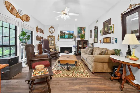 a living room with furniture a fireplace and a table