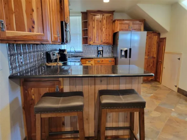 a kitchen with a sink cabinets and stainless steel appliances