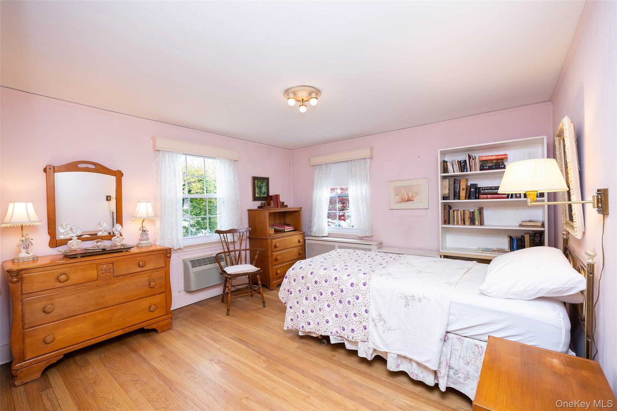 65 Old Mill Road Manhasset, NY 11030 - Photo 11 of 17 a bedroom with a bed window and dresser