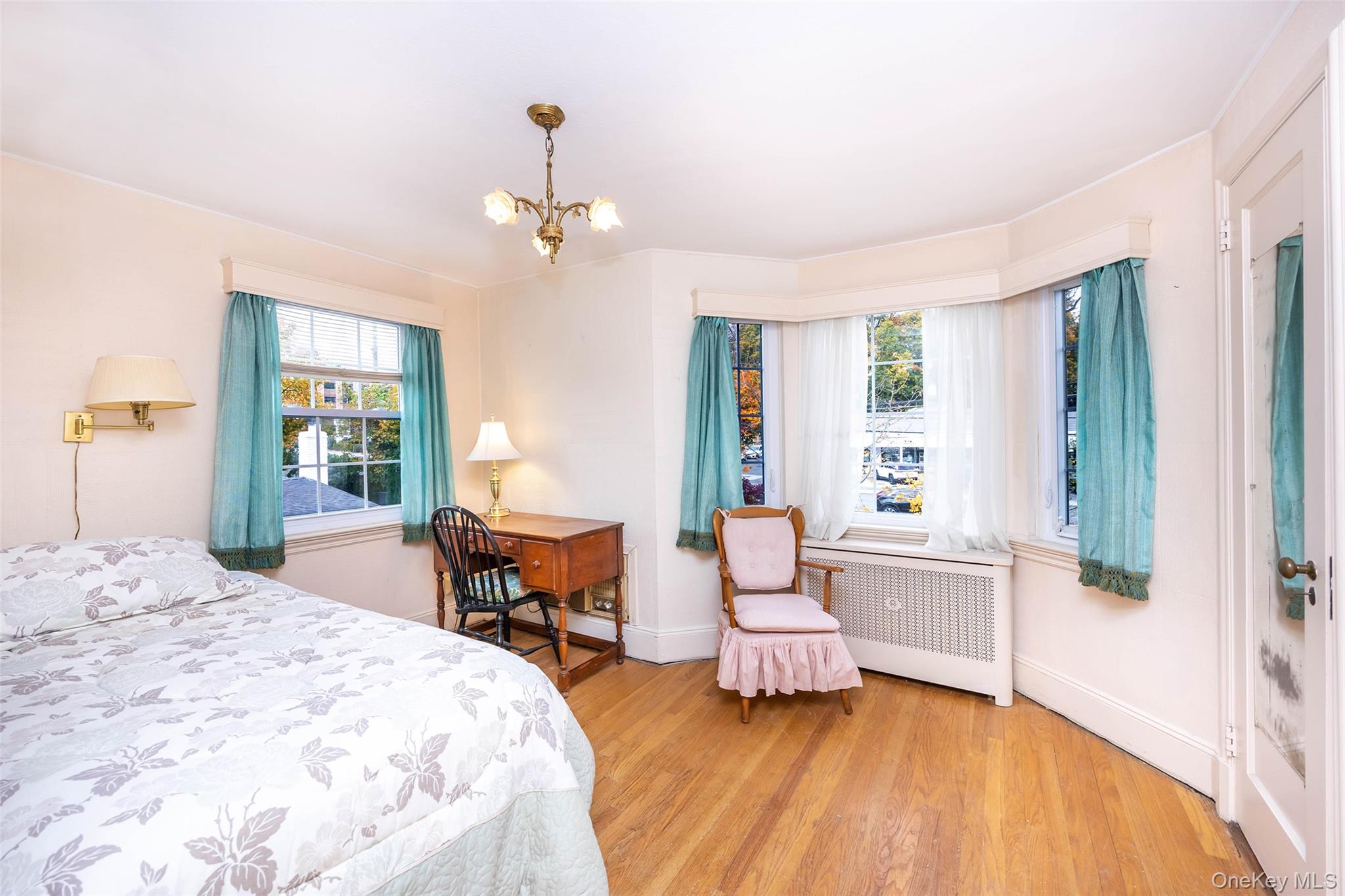 65 Old Mill Road Manhasset, NY 11030 - Photo 12 of 17 a bedroom with a bed and wooden floor