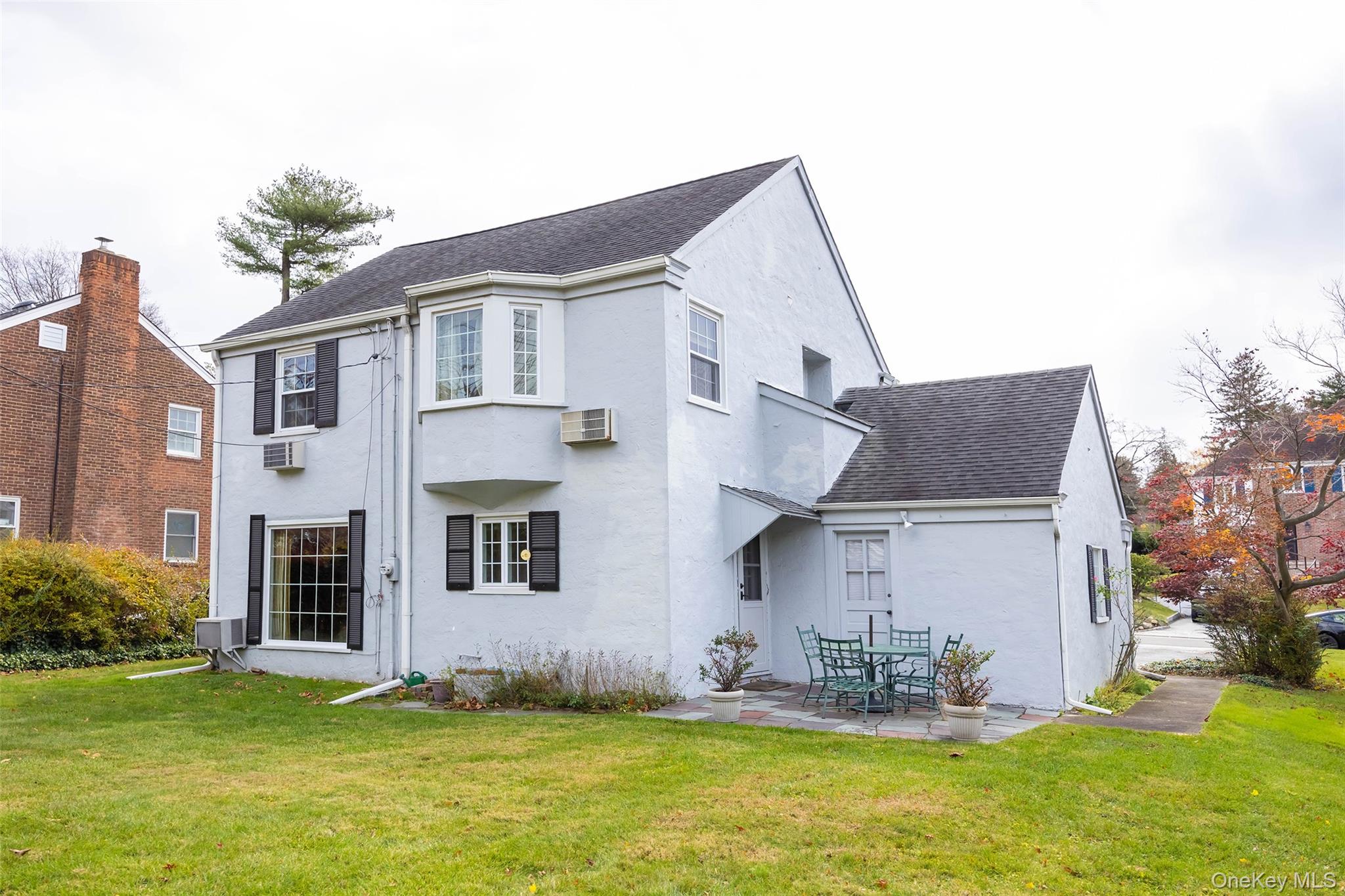 65 Old Mill Road Manhasset, NY 11030 - Photo 14 of 17 a house that has a big yard in front of it