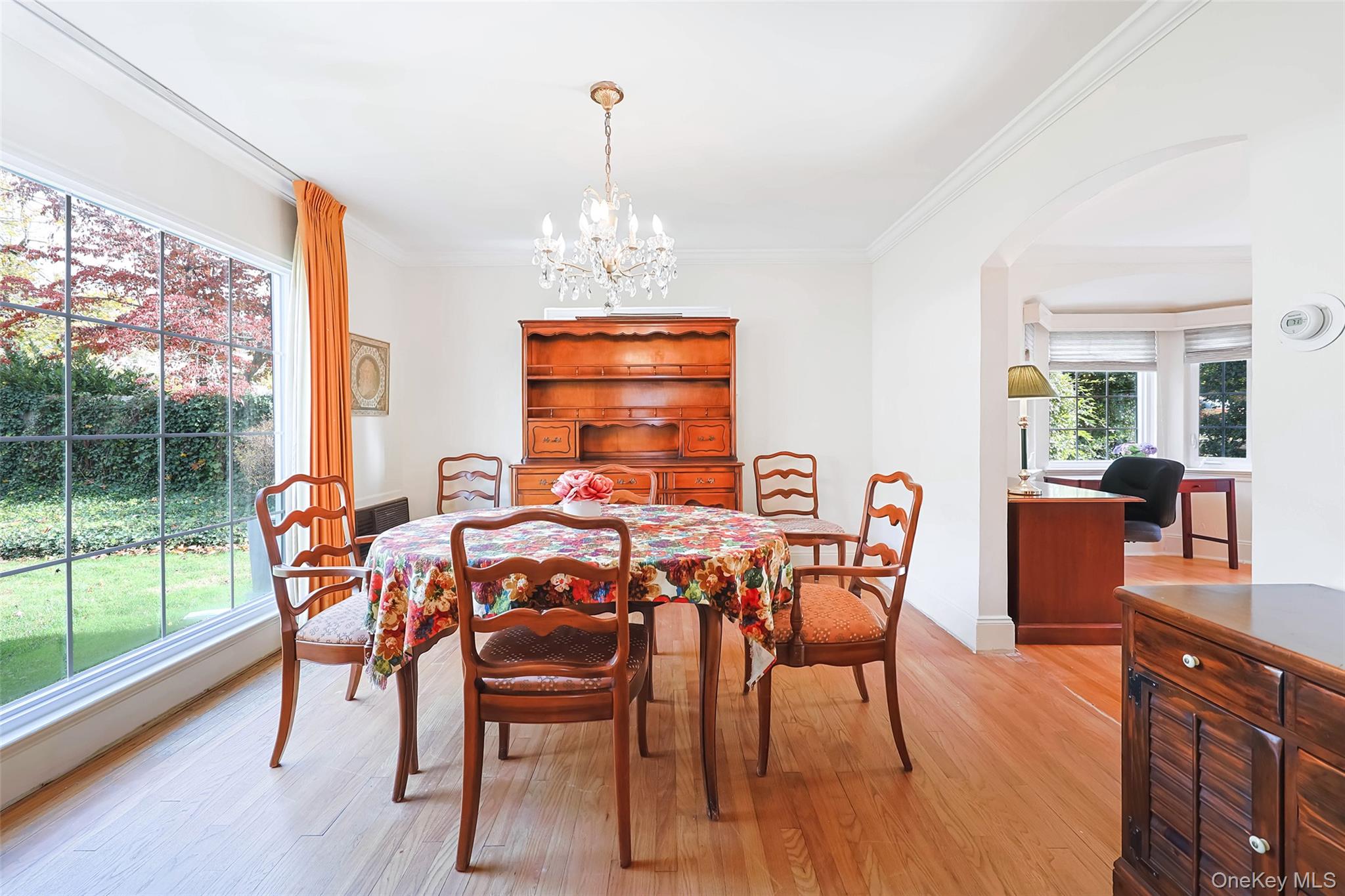 65 Old Mill Road Manhasset, NY 11030 - Photo 6 of 17 a dining room with furniture a chandelier and wooden floor