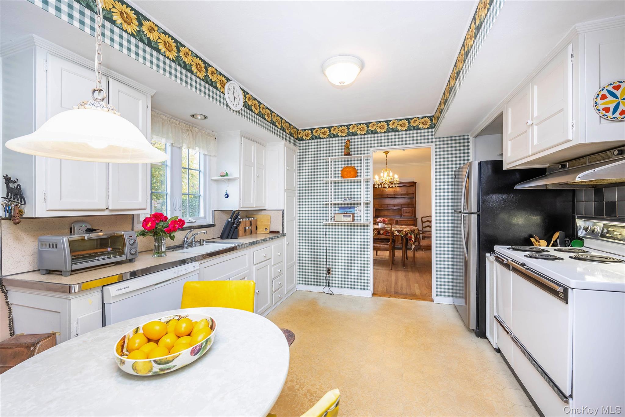 65 Old Mill Road Manhasset, NY 11030 - Photo 7 of 17 a kitchen with stainless steel appliances kitchen island granite countertop a stove and cabinets