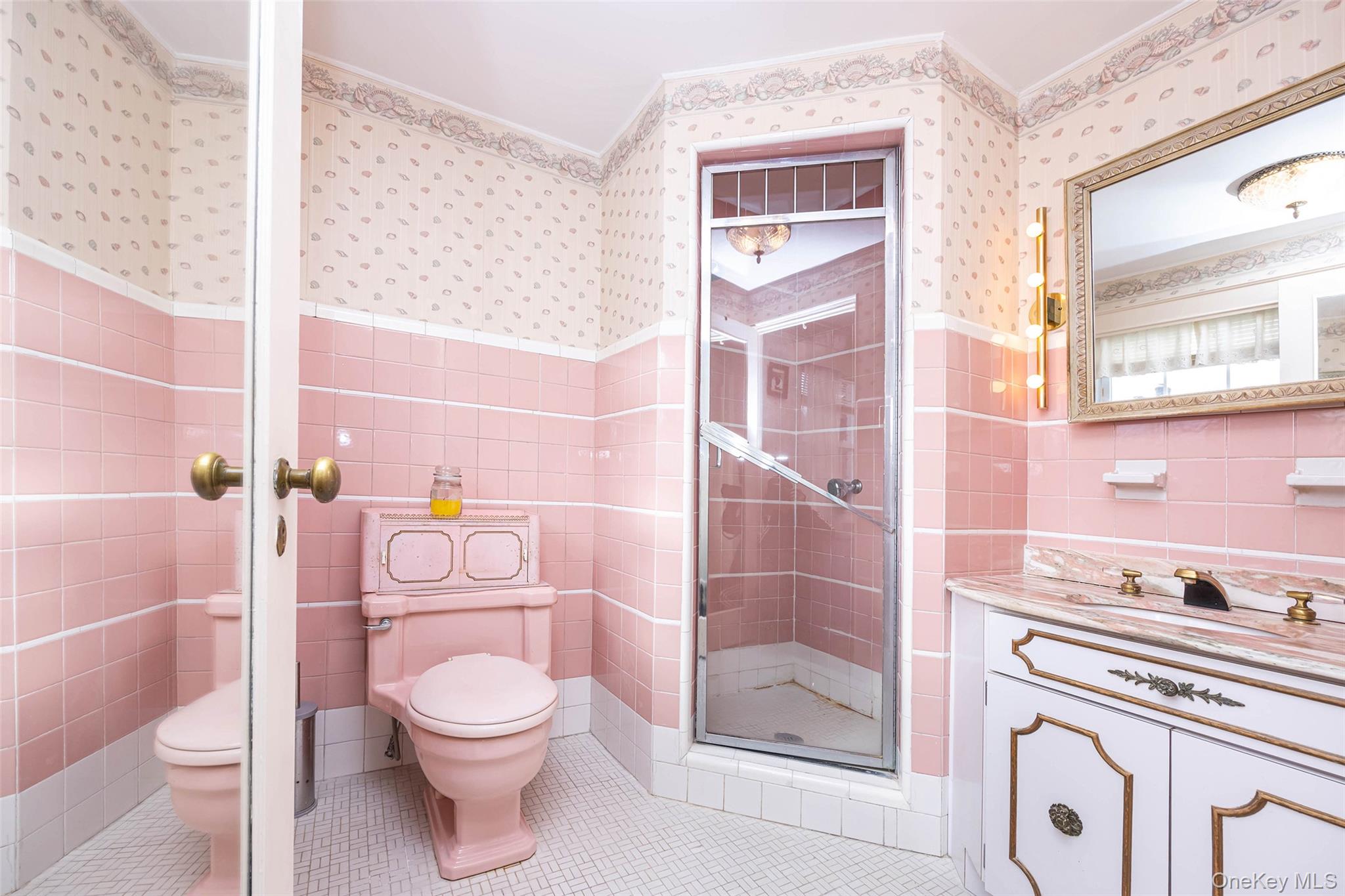 65 Old Mill Road Manhasset, NY 11030 - Photo 10 of 17 a bathroom with a granite countertop toilet a sink and a shower