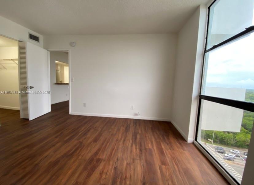 13499 Biscayne Boulevard, Unit 1507 North Miami, FL 33181 - Photo 18 of 32 a view of empty room with wooden floor and fan