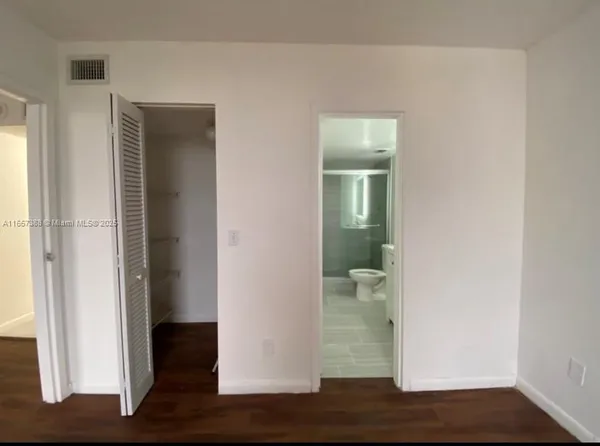 a view of hallway with wooden floor