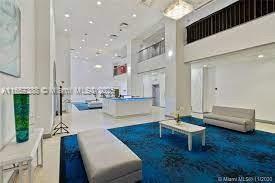 13499 Biscayne Boulevard, Unit 1507 North Miami, FL 33181 - Photo 30 of 32 a living room with kitchen island furniture and a view of kitchen