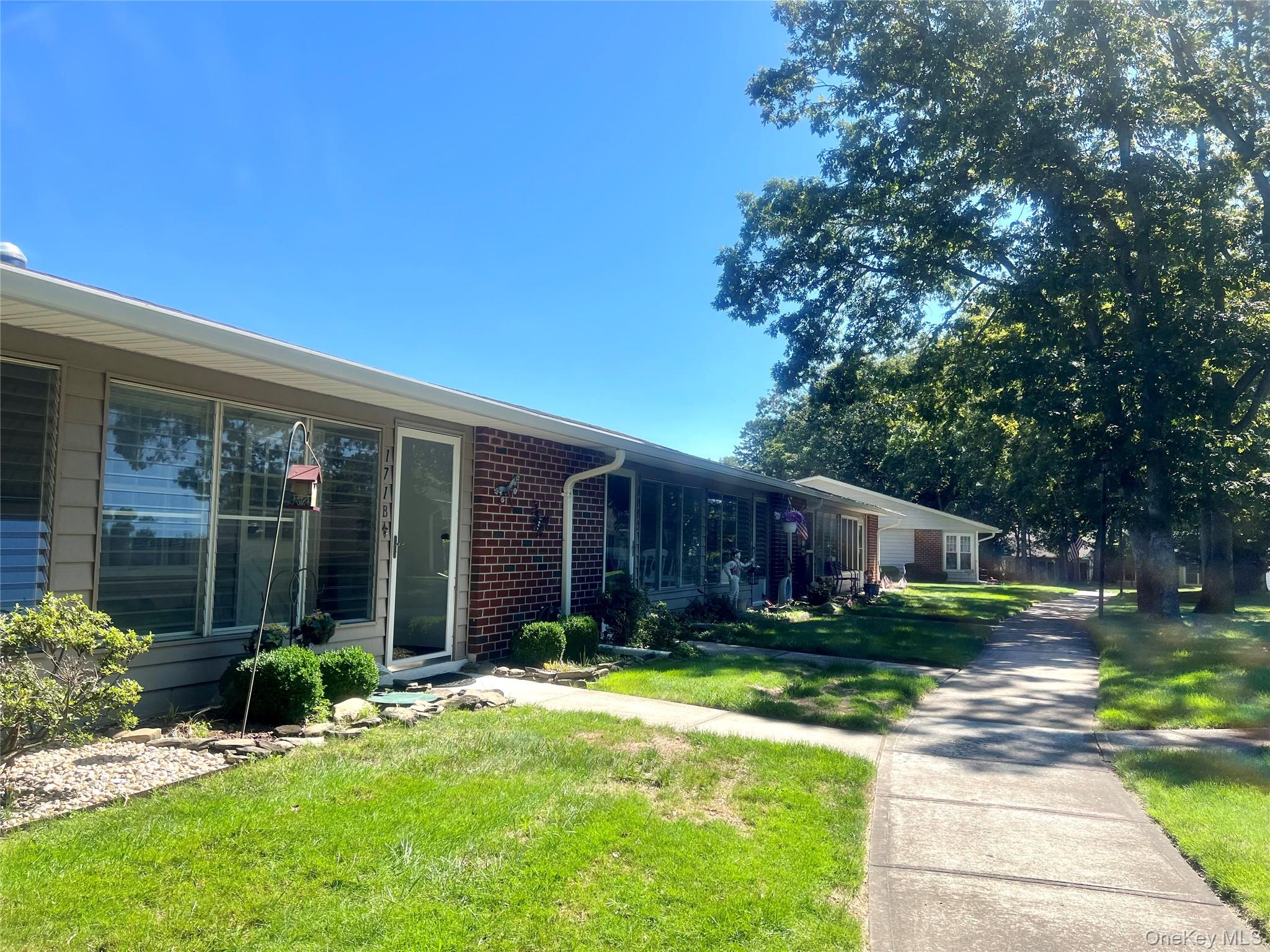171 B Ventry Court, Unit 171B Ridge, NY 11961 - Photo 1 of 19 a view of a house with yard and sitting area