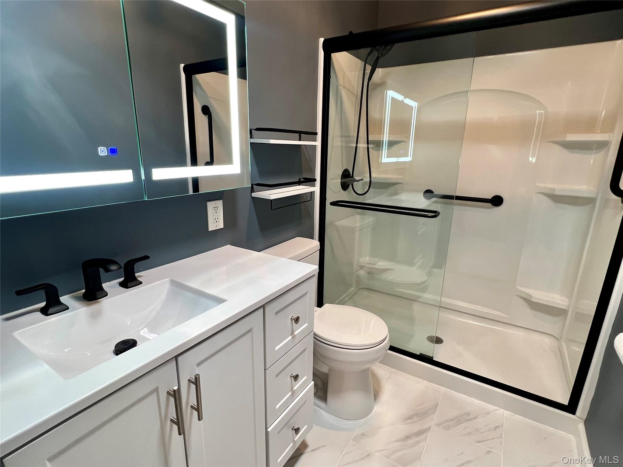 171 B Ventry Court, Unit 171B Ridge, NY 11961 - Photo 12 of 19 a bathroom with a sink toilet and shower