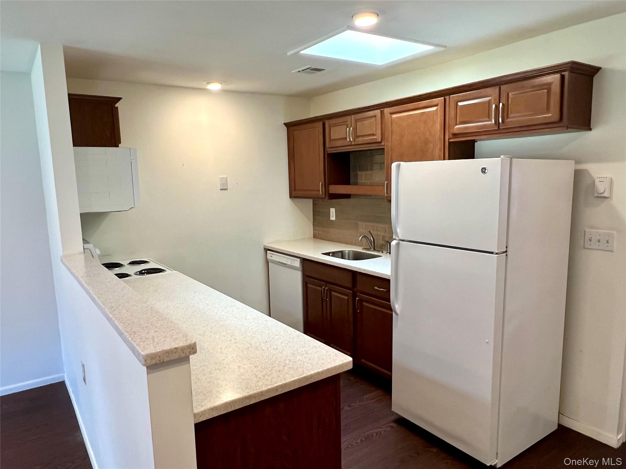 171 B Ventry Court, Unit 171B Ridge, NY 11961 - Photo 6 of 19 a kitchen with a refrigerator sink and stove