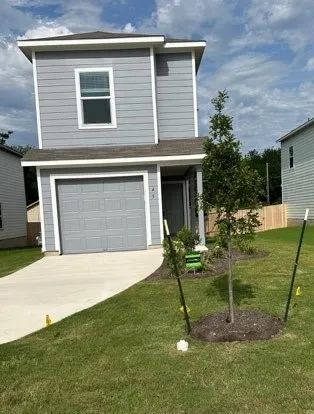 a backyard of a house with table and chairs