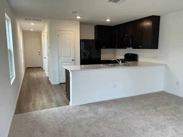 a kitchen with stainless steel appliances a refrigerator and a stove top oven