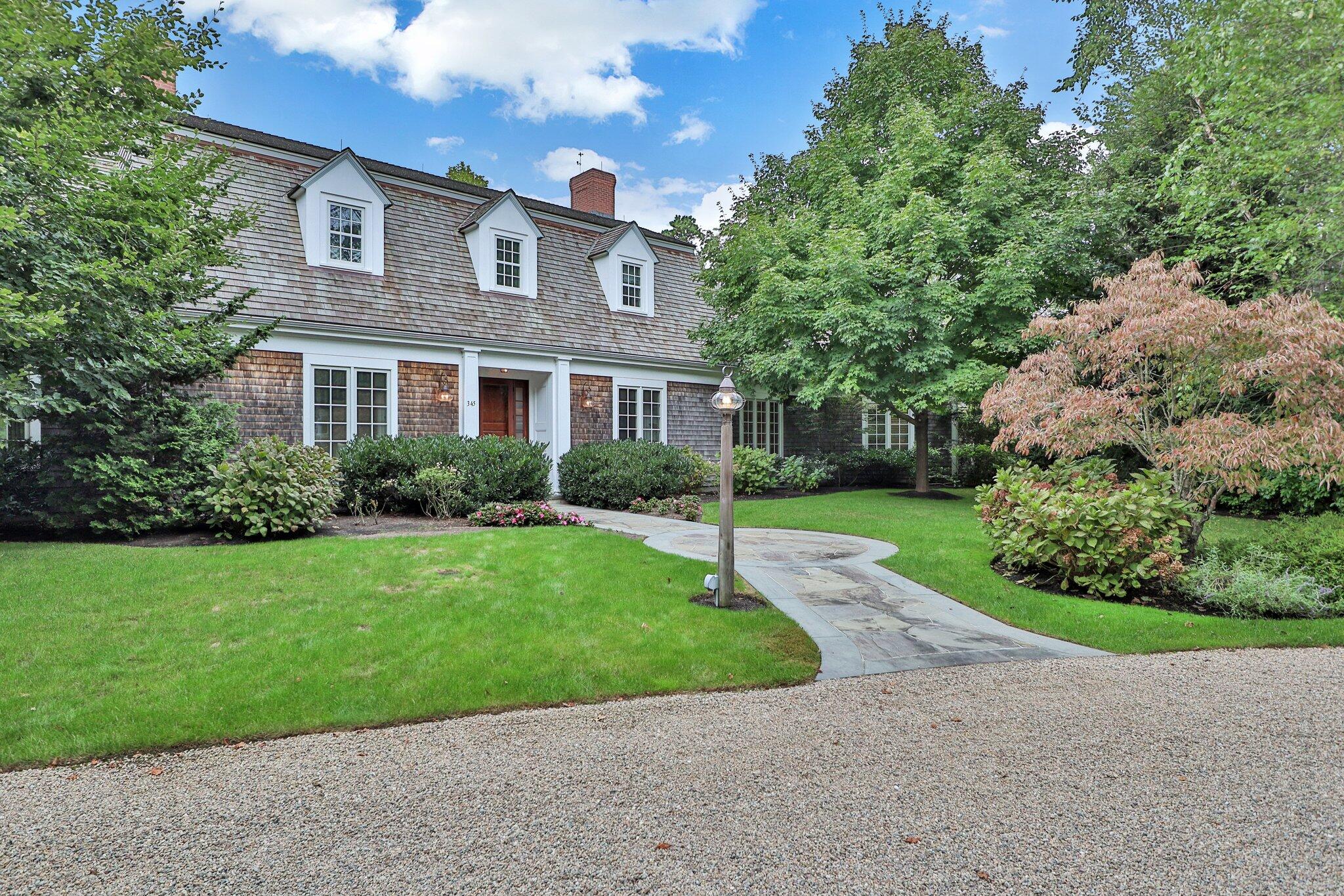 345 Windswept Way Osterville, MA 02655 - Photo 2 of 66 a front view of a house with a yard