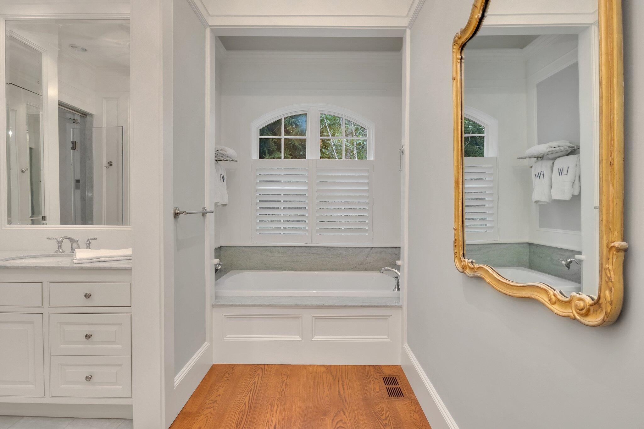 345 Windswept Way Osterville, MA 02655 - Photo 22 of 66 a bathroom with a tub a sink and a window