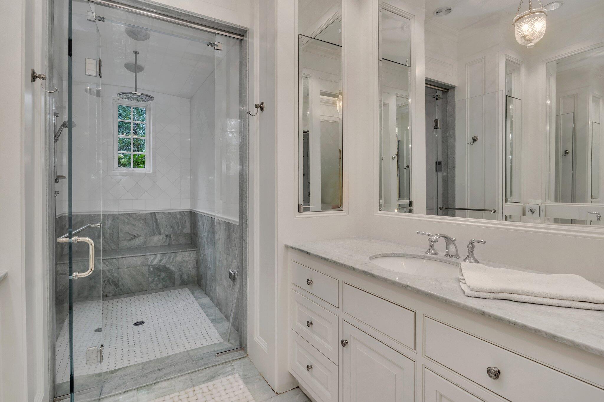 345 Windswept Way Osterville, MA 02655 - Photo 24 of 66 a bathroom with a shower sink and mirror