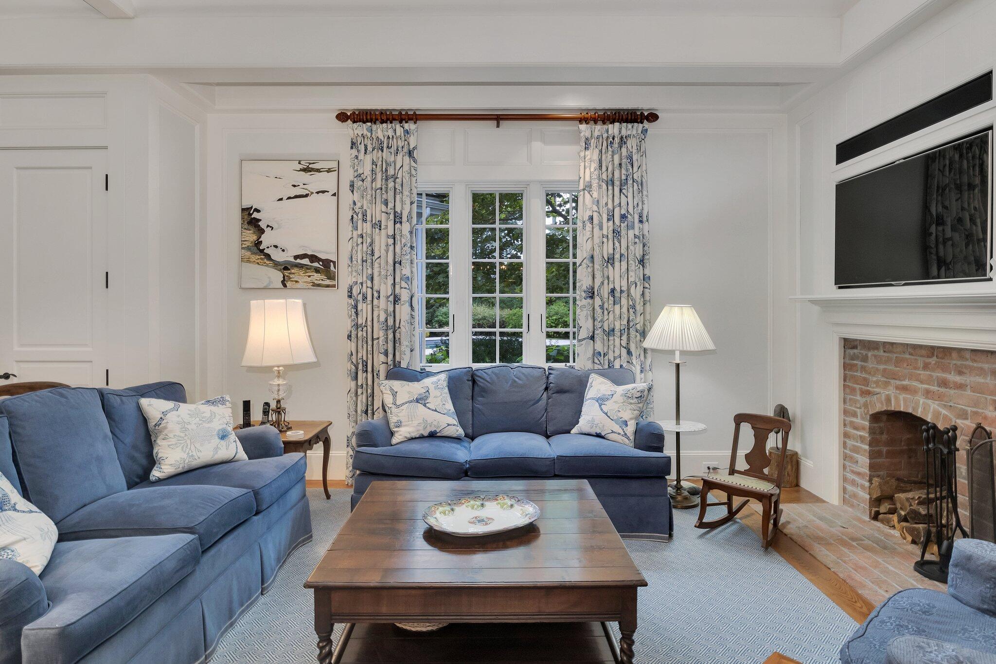 345 Windswept Way Osterville, MA 02655 - Photo 32 of 66 a living room with furniture a fireplace and a flat screen tv
