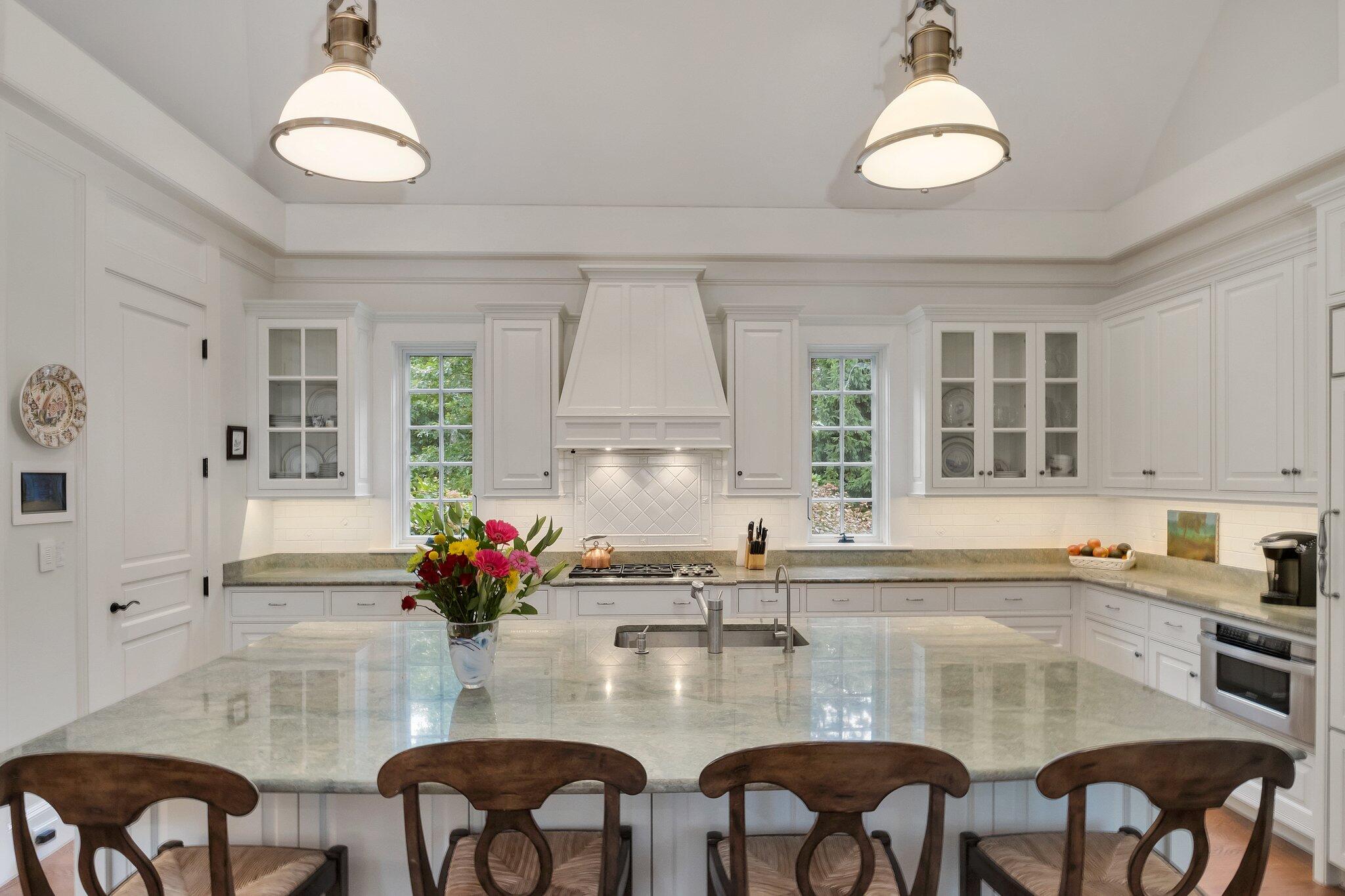 345 Windswept Way Osterville, MA 02655 - Photo 37 of 66 a kitchen with stainless steel appliances granite countertop a dining table chairs and white cabinets