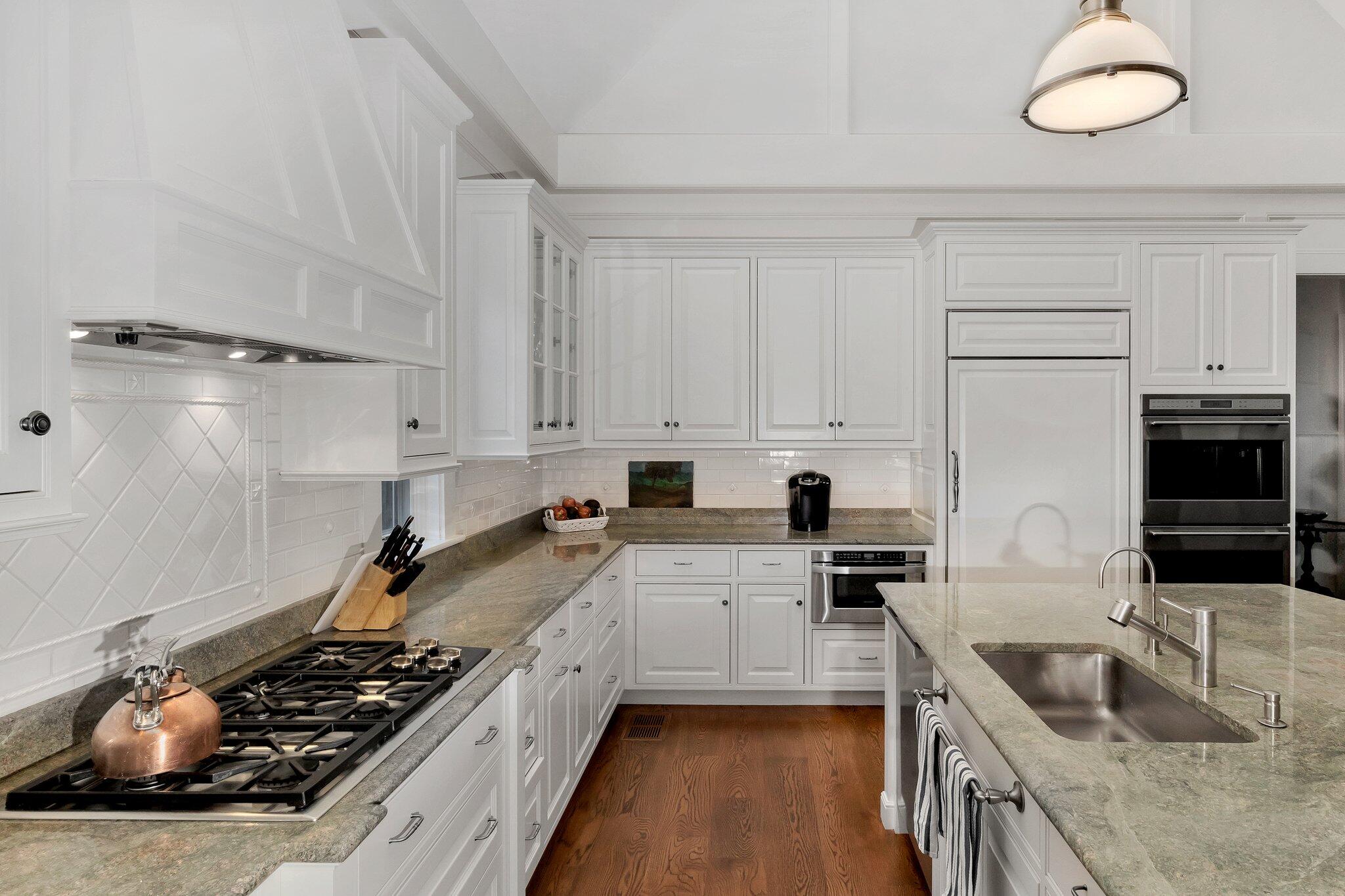 345 Windswept Way Osterville, MA 02655 - Photo 38 of 66 a kitchen with sink a stove and cabinets