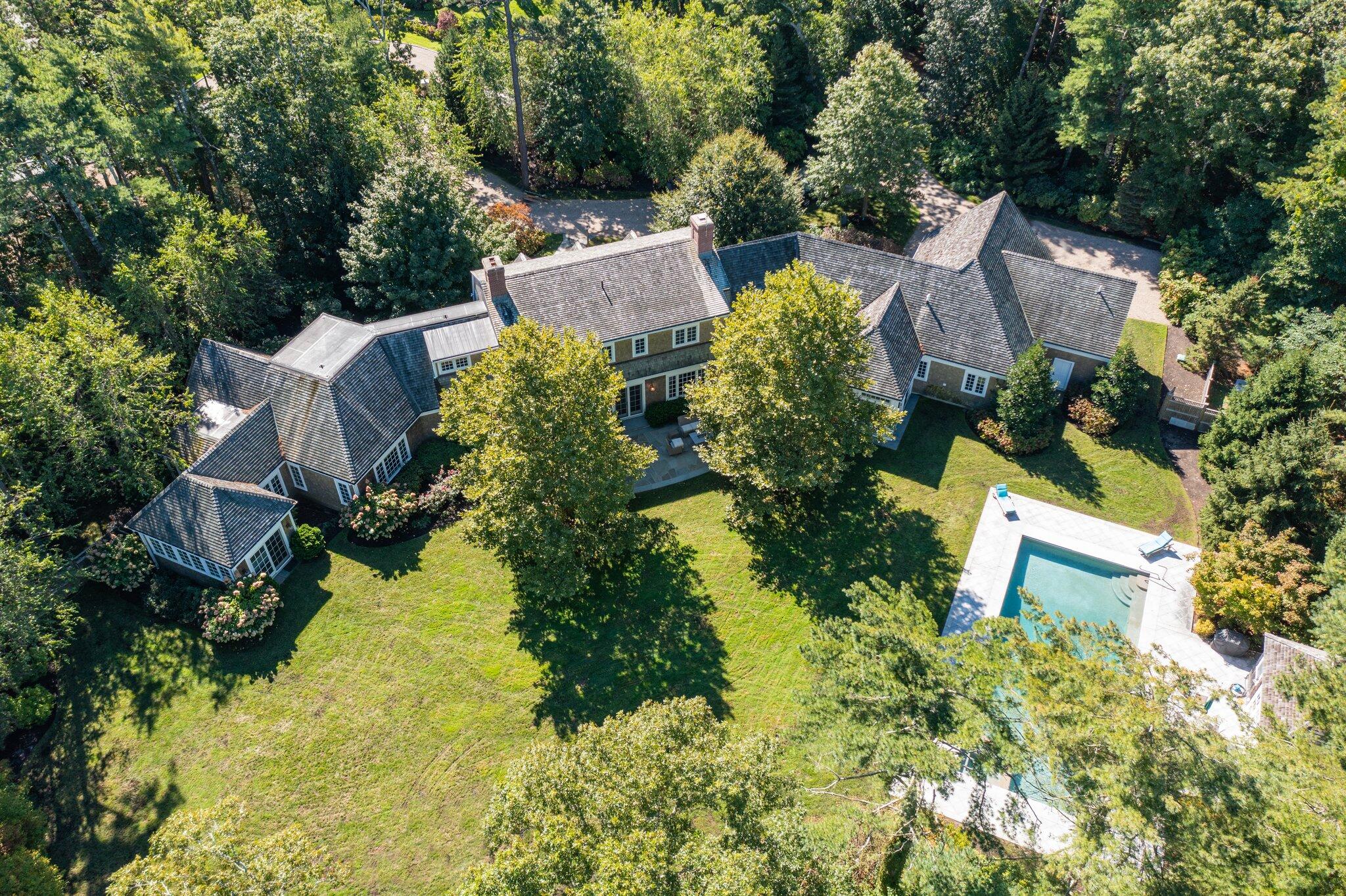 345 Windswept Way Osterville, MA 02655 - Photo 4 of 66 an aerial view of a house with a yard and trees