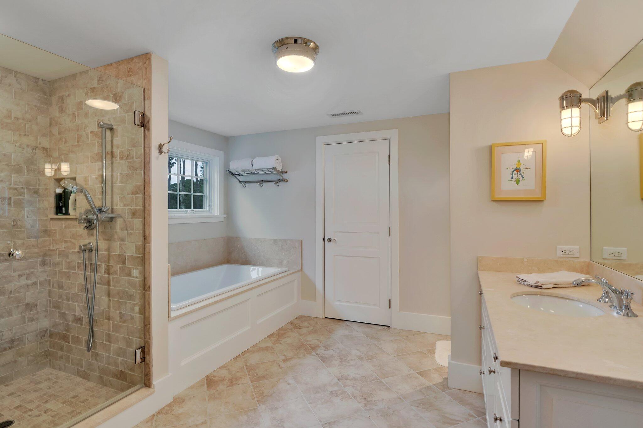 345 Windswept Way Osterville, MA 02655 - Photo 46 of 66 a bathroom with a tub sink and shower