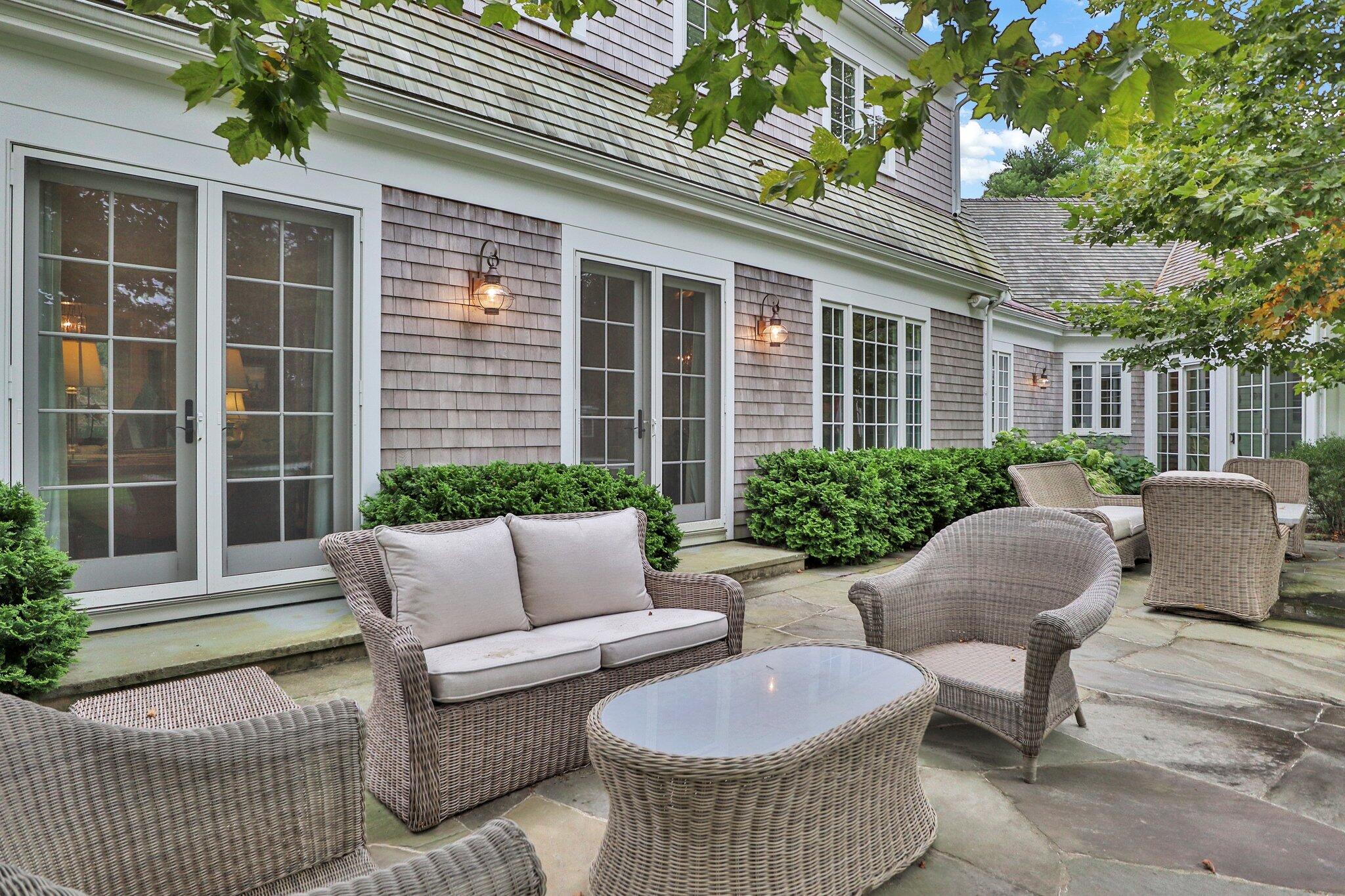 345 Windswept Way Osterville, MA 02655 - Photo 55 of 66 a view of a patio with couches and a potted plant