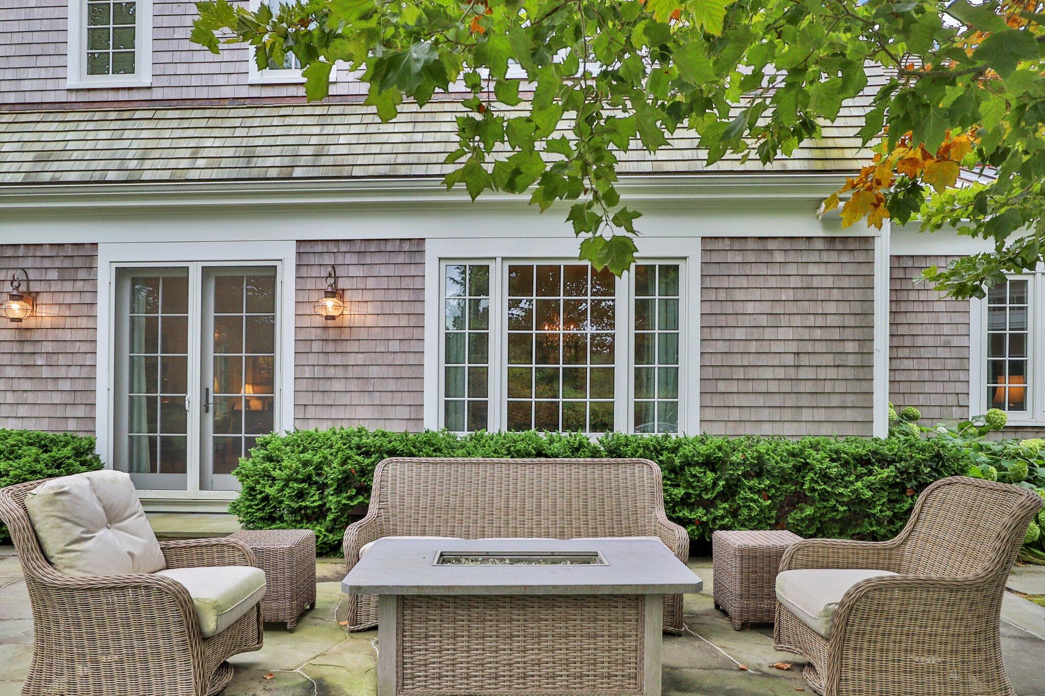 345 Windswept Way Osterville, MA 02655 - Photo 56 of 66 a view of a patio with couches chairs and potted plants