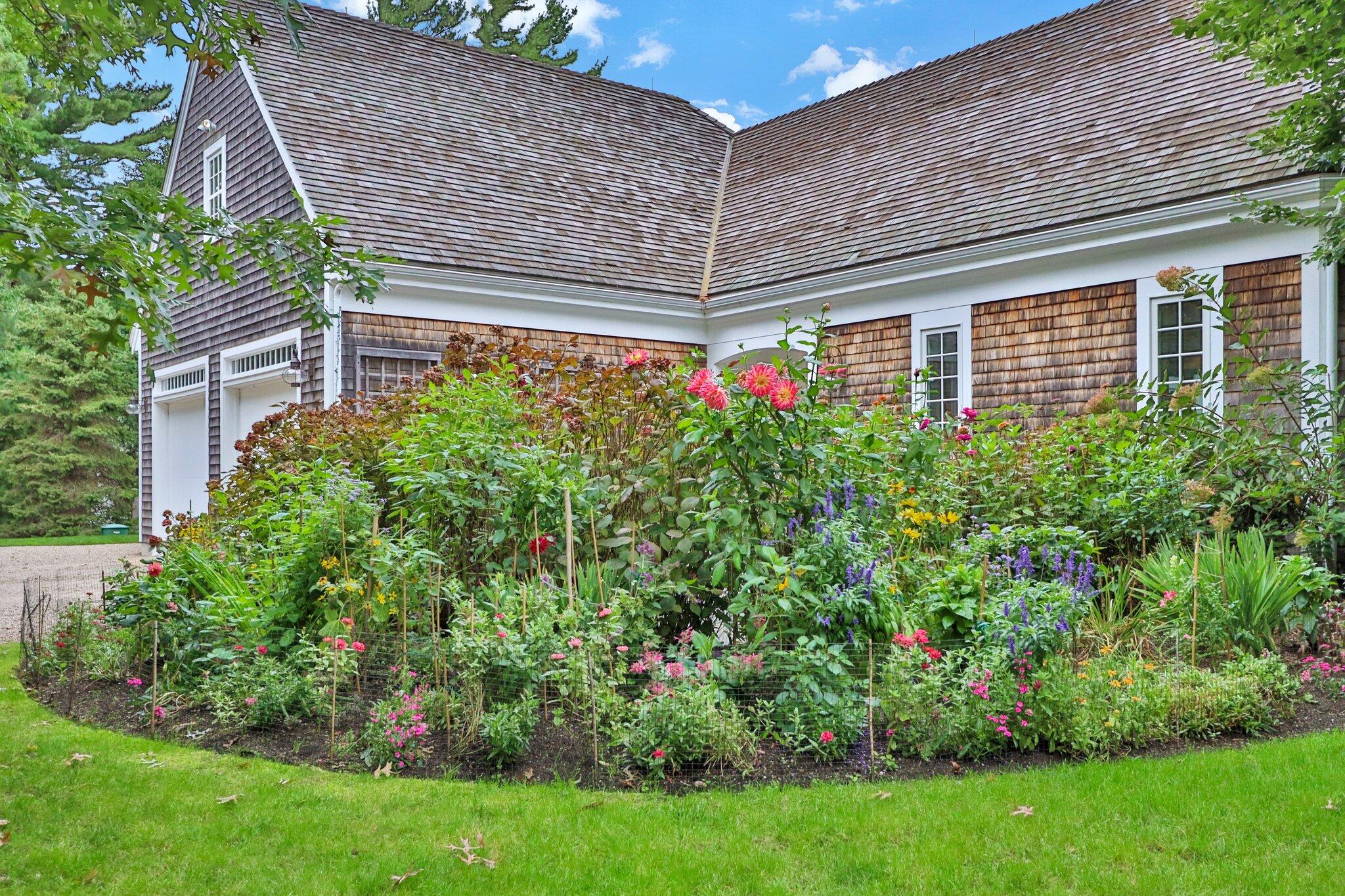 345 Windswept Way Osterville, MA 02655 - Photo 58 of 66 a backyard of a house with plants and large tree