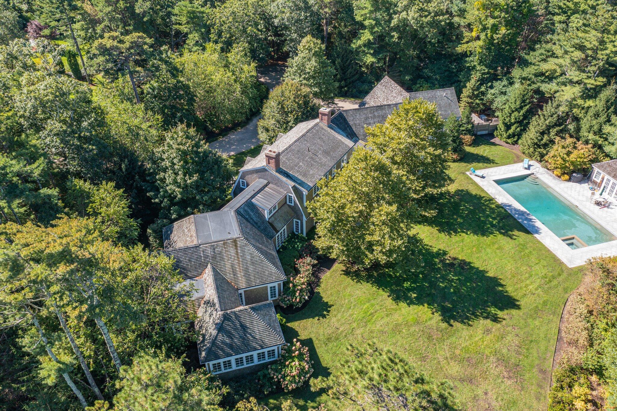 345 Windswept Way Osterville, MA 02655 - Photo 62 of 66 an aerial view of a house with a yard lake and trees all around