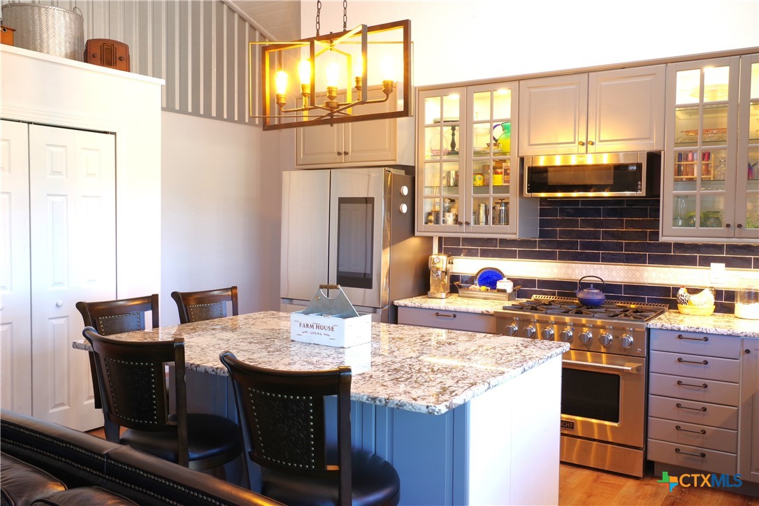 15049 Ranch Road 101 Kempner, TX 76539 - Photo 12 of 25 a kitchen with a stove and a refrigerator