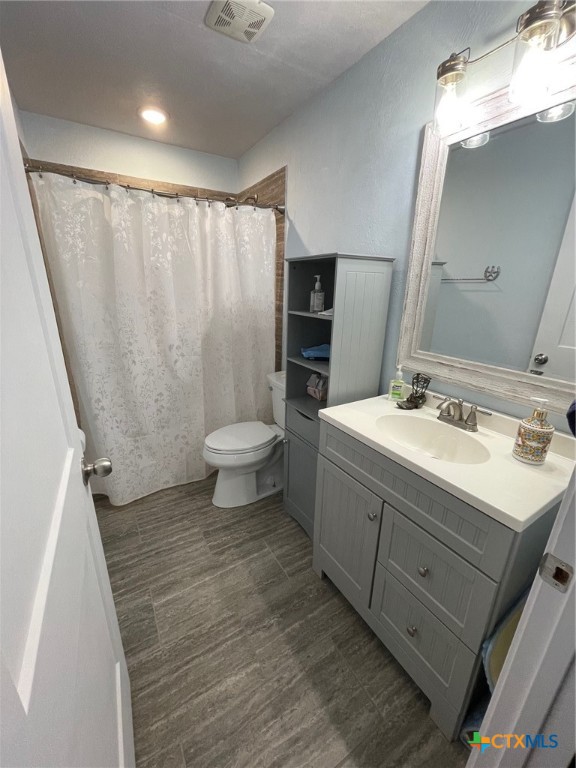 15049 Ranch Road 101 Kempner, TX 76539 - Photo 14 of 25 a bathroom with a double vanity sink toilet and shower