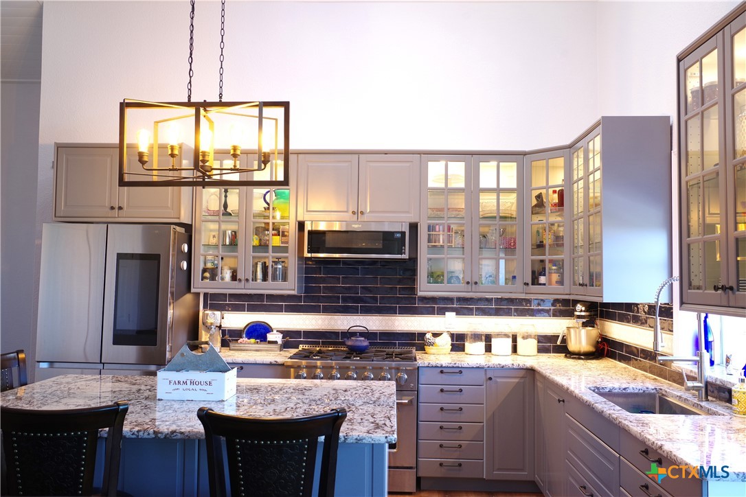 15049 Ranch Road 101 Kempner, TX 76539 - Photo 5 of 25 a kitchen with a stove a sink and a refrigerator