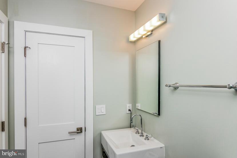 29 17th Street Southeast Washington, DC 20003 - Photo 14 of 30 a bathroom with a sink a mirror and a light fixture