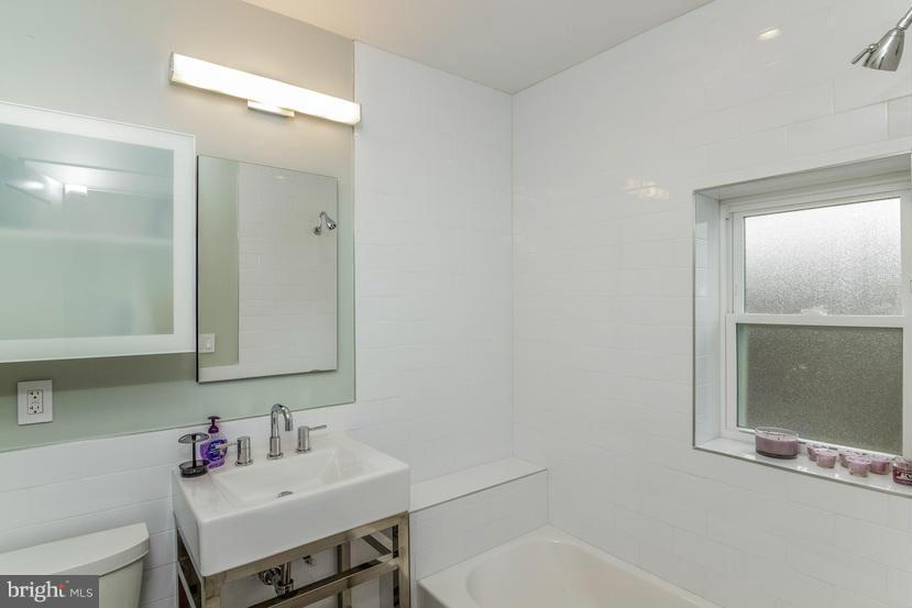 29 17th Street Southeast Washington, DC 20003 - Photo 15 of 30 a bathroom with a sink vanity tub and a mirror