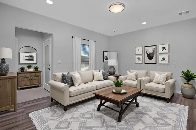 a living room with furniture rug and window
