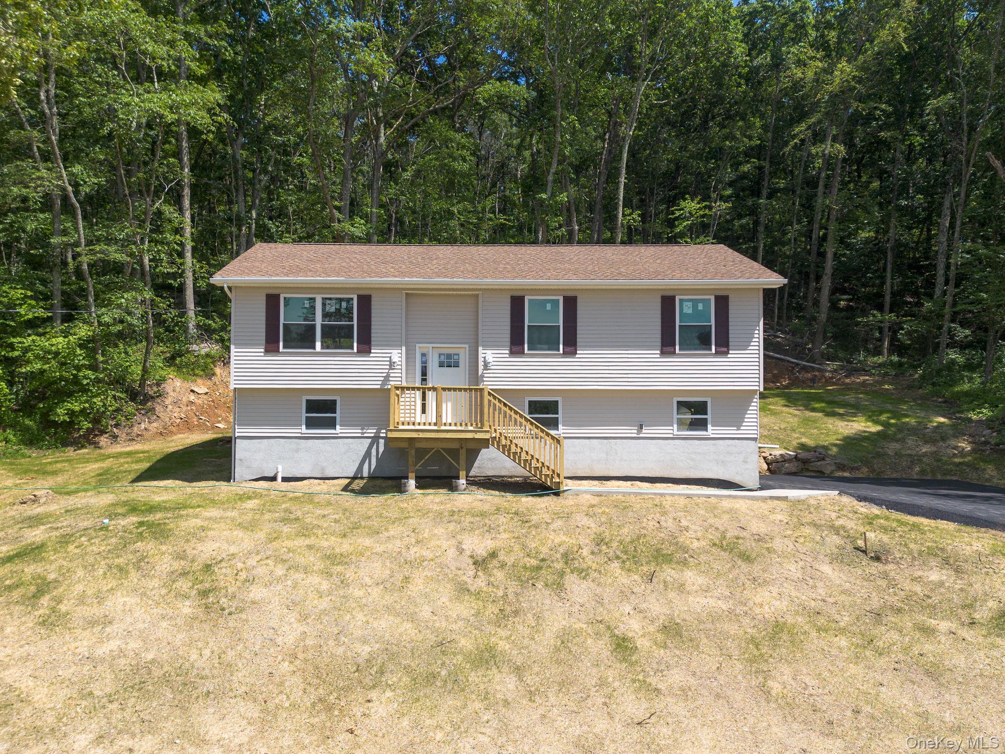a house that has a tree in front of it