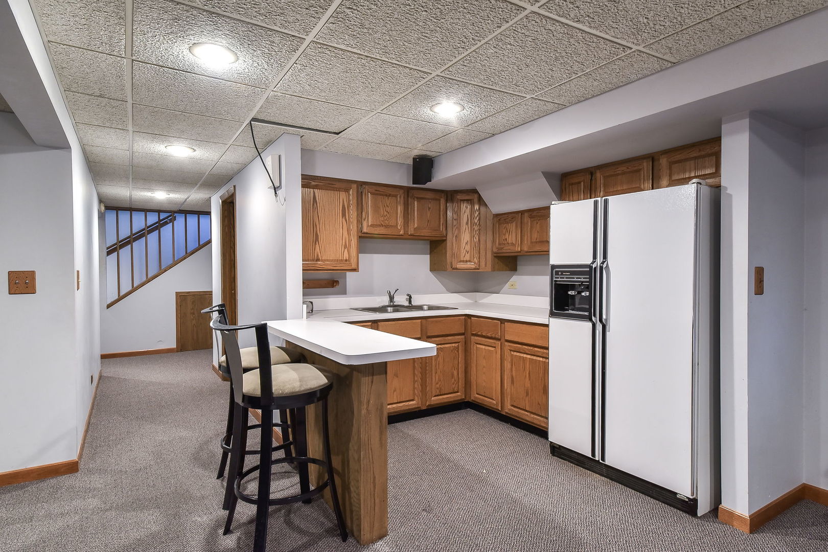 8S526 River Drive Naperville, IL 60565 - Photo 19 of 35 a kitchen with sink a refrigerator and chairs