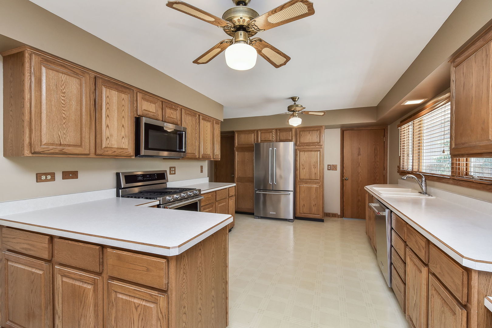 8S526 River Drive Naperville, IL 60565 - Photo 6 of 35 a kitchen with stainless steel appliances a stove refrigerator sink and microwave