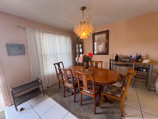 a view of a dining room with furniture and window
