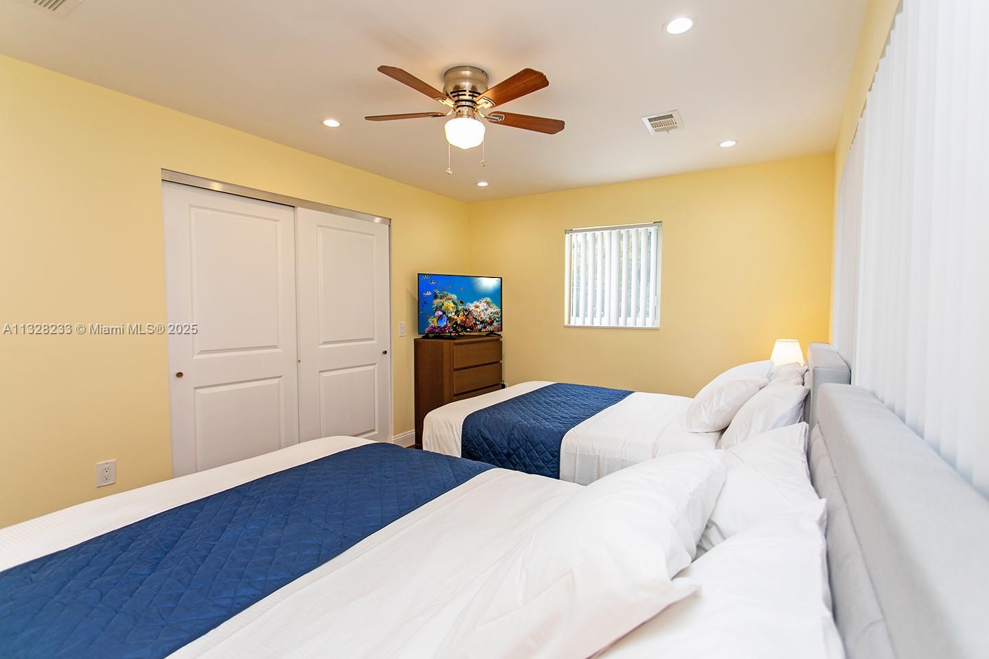 809 South 17th Avenue Hollywood, FL 33020 - Photo 24 of 45 a bedroom with a bed and a ceiling fan