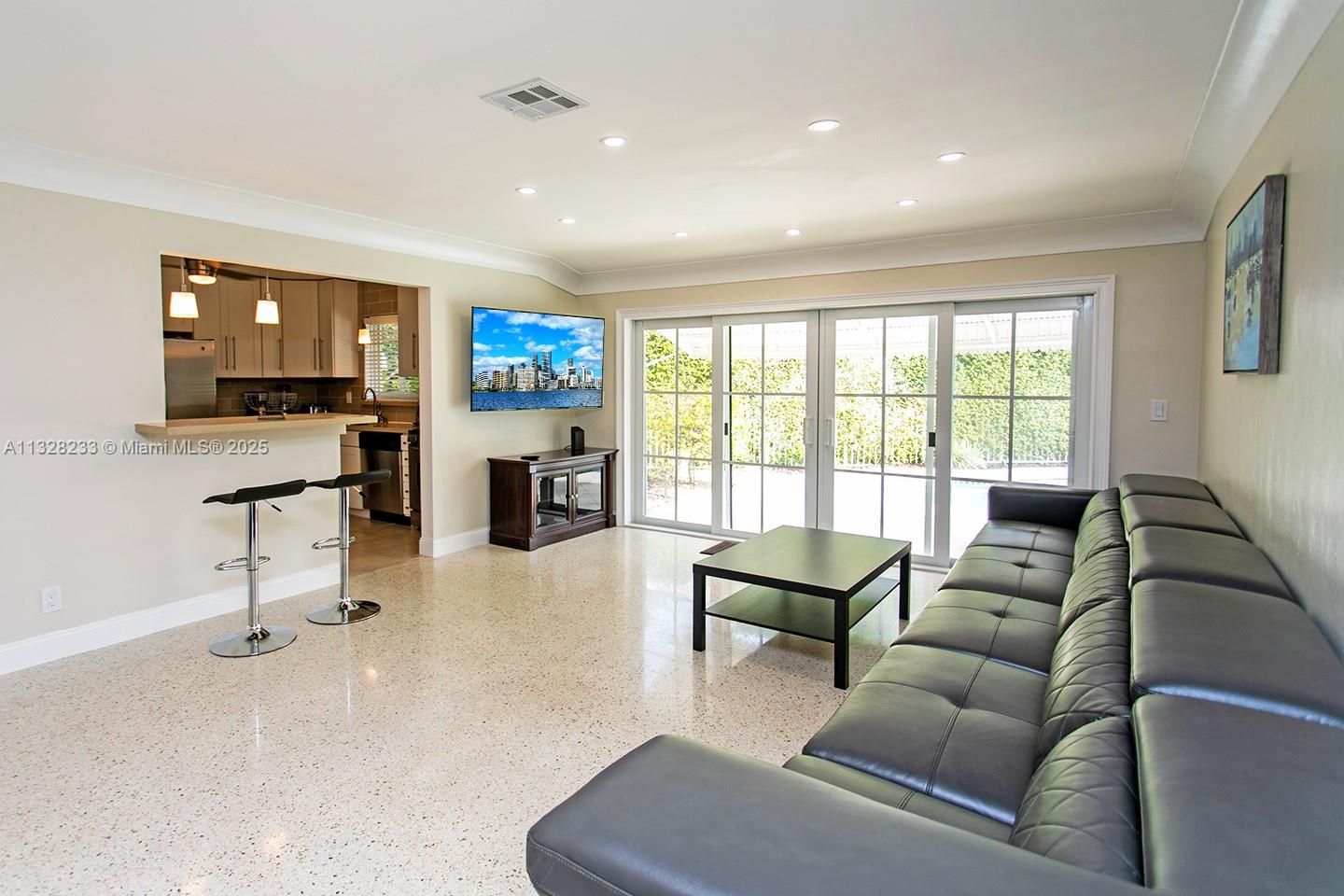 809 South 17th Avenue Hollywood, FL 33020 - Photo 32 of 45 a living room with furniture and a flat screen tv