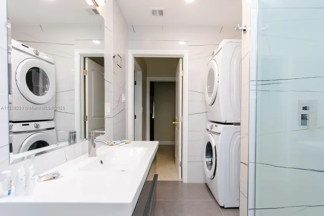 a bathroom with a double vanity sink and a mirror